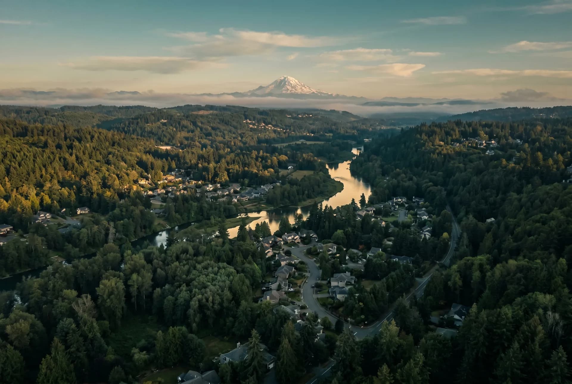 Western Washington landscape — rolling forested hills, river valleys, and Mt. Rainier in the distance